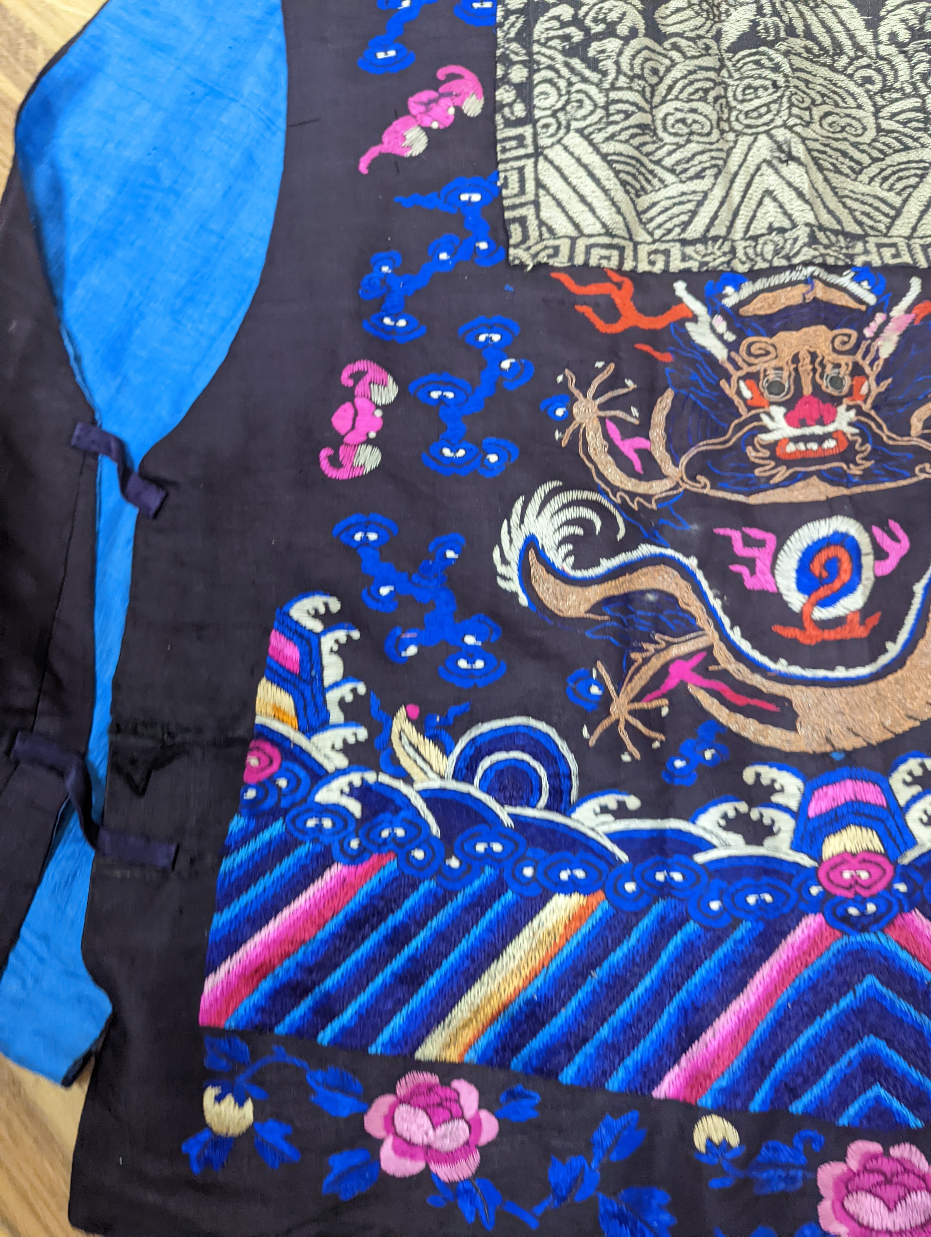 A 1920's Chinese dragon embroidered waistcoat, a cream silk drawn thread dress and a silk crepe black and patterned reversible kimono (3 items).